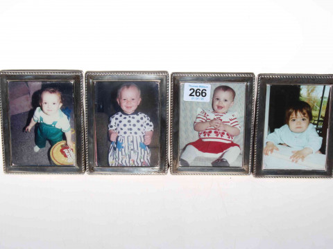 Set of four small silver photograph frames.