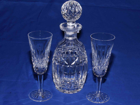 Waterford Crystal decanter and two champagne flutes.