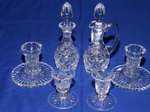 Waterford Crystal vinegar and condiment bottles, two pairs of dwarf candlesticks.