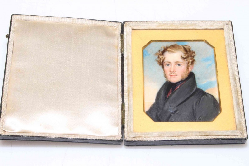 Portrait miniature of young gentleman in travel case with gilt slip, first half 19th Century, overall 9cm by 7.5cm.