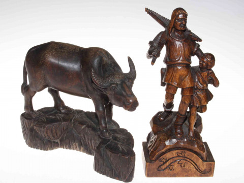 Carved wood buffalo and figure carving of man and child with crossbow...