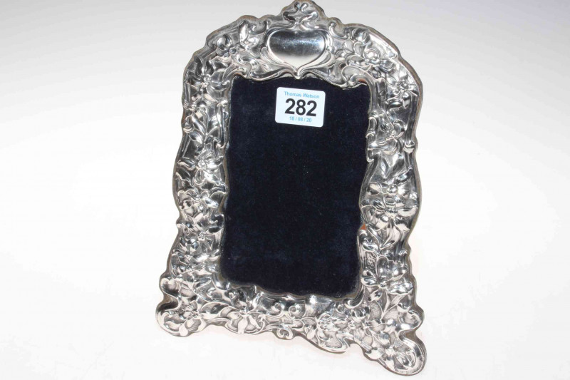 Ornate silver mounted easel photograph frame, shaped and embossed with foliage, maker RH, Birmingham 1993.