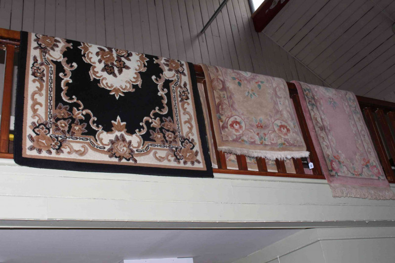 Pink ground Chinese runner 3.00 by 0.68, fawn ground Chinese rug 1.55 by 0.77 and black ground Belgian rug 1.70 by 1.18 (3).