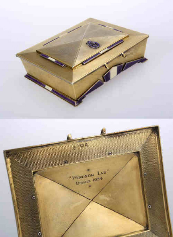Horse racing interest: A George V silver gilt and enamel cigarette box, Mappin & Webb, London 1934, in the Art Deco style, the hinged rectangular lid applied with four three-section blue and white enamel bars and a crest, the front applied with three enam