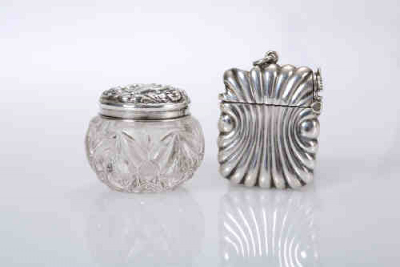 A late 19th century silver vesta and cigar cutter combination, ''The Unity Patent'', Horton & Aliday, date mark indistinct; together with a silver topped dressing table jar. (2)