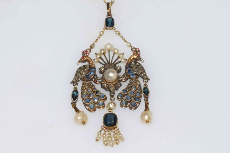 Fine 1920's double peacock pendant set with diamonds, sapphires, rubies and pearls, hung on fine chain with seed pearls, boxed.
