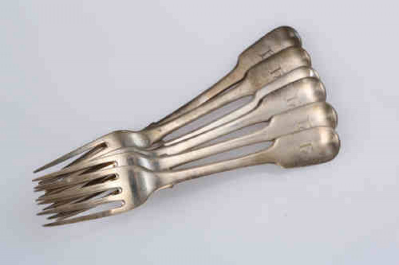 A set of five George III silver dessert forks, Thomas Wallis & Jonathan Hayne, London 1818, Fiddle pattern, each monogrammed; together with another Fiddle pattern dessert fork, Richard Poulden, London 1820, engraved with a monogram. Gross 7.3 troy ozs