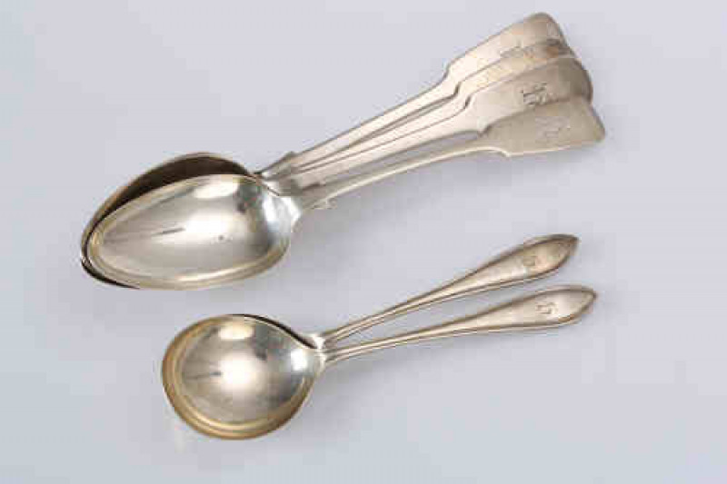 A pair of George IV silver table spoons, Thomas Watson, Newcastle 1824, Fiddle pattern, engraved with a monogram; together with two further Newcastle silver table Fiddle pattern spoons and a pair of Sheffield silver serving spoons. (6) Gross 10.8 troy ozs