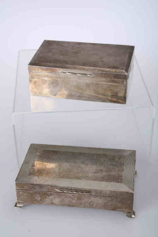 A George V silver cigarette box, Birmingham 1922, of plain rectangular form; together with another silver cigarette box. (2)