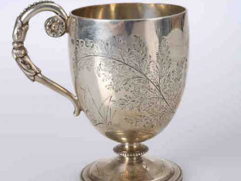 A Victorian silver mug, Thomas Smily, London 1871, the ovoid cup engraved...