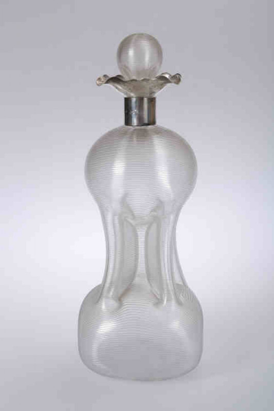 A late Victorian silver and cut glass ''cluck cluck'' decanter, Mappin & Webb, London 1898, the waisted body with concentric rings, the silver collar issuing four spouts. 30cm