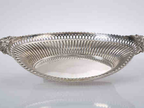A silver dish, Walker & Hall, date letter indistinct, oval, with leaf...