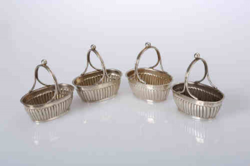 A set of four Victorian silver salts, Horace Woodward & Co, London 1889, of basket form, each with part fluted body and double bar handle with ball finial. 2.6 troy ozs, 5.5cm wide