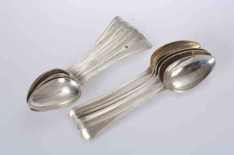 A matched set of twelve George III silver table spoons, Old English Thread pattern, six, Eley, Fearn & Chawner, London 1809; three, HS, London 1805; two, HS, London 1803 and one, Richard Crossley, London 1801; each engraved with a crest. Gross 24.5 troy o