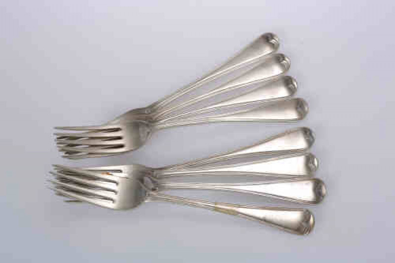 A matched set of eight 19th century silver dinner forks, Old English Thread pattern, four, Eley, Fearn & Chawner, London 1809; three, George Adams, London 1846; one, SH, London 1805; each engraved with a crest. Gross 17.5 troy ozs
