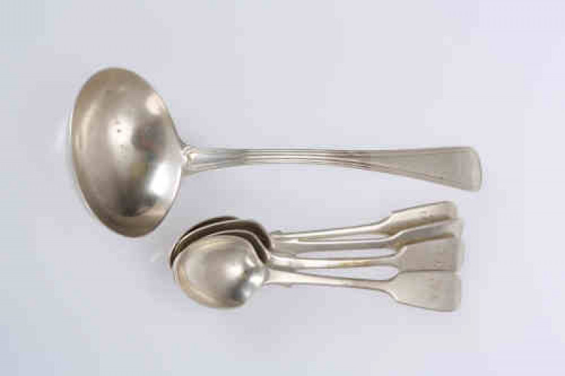 A George III silver sauce ladle, Eley, Fearn & Chawner, London 1809, Old English Thread pattern, engraved with a crest; together with a group of four Victorian silver teaspoons. Gross 4.3 troy ozs