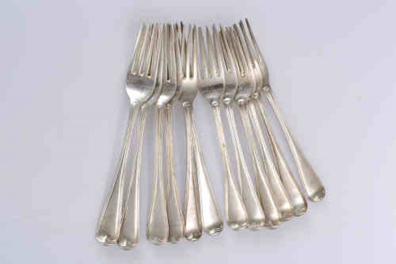 A matched set of twelve George III silver dessert forks, Old English Thread pattern, five, Eley, Fearn & Chawner, London 1809; four, HS, London 1805; two, indistinctly marked; and one, London 1828. Gross 15.3 troy ozs