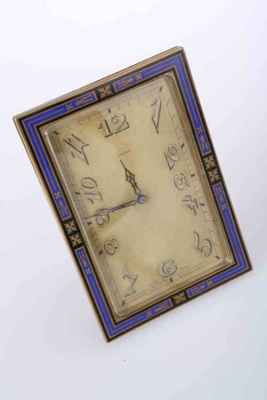 An Art Deco eight day enamel strut clock, the rectangular dial, with Arabic numerals, within a blue and black enamelled frame, with Swiss 15  jewel lever escapement movement. 12cm by 8.5cm