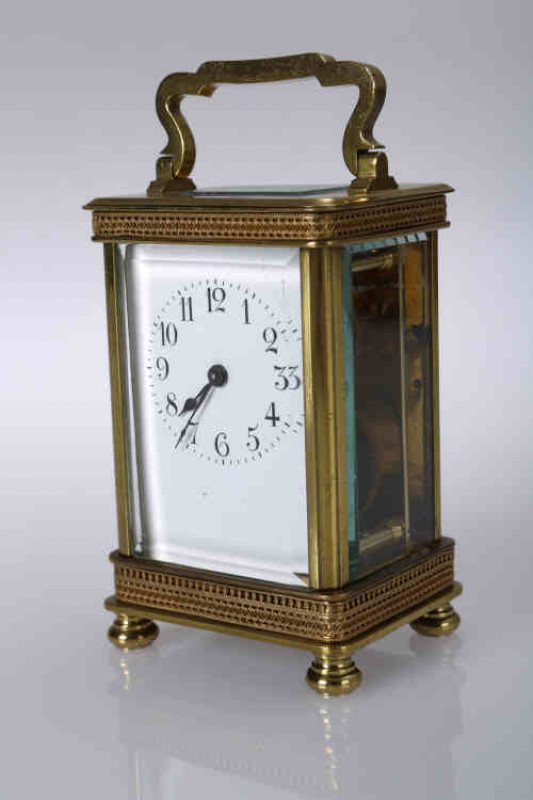 Richard & Co, Paris, a brass cased carriage clock, late 19th century, the four glass case with glazed aperture to the rectangular  top, above an applied band of conjoining S-scrolls, over a white enamel dial with Arabic numerals, on a plinth base applied 