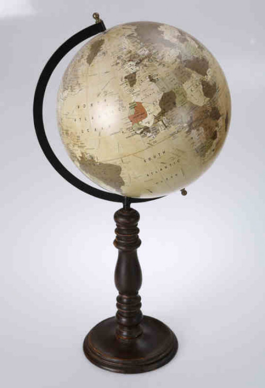 An early 20th century 12'' globe, spinning on a black lacquered meridian, raised on a turned baluster stem with moulded circular base. 64cm high