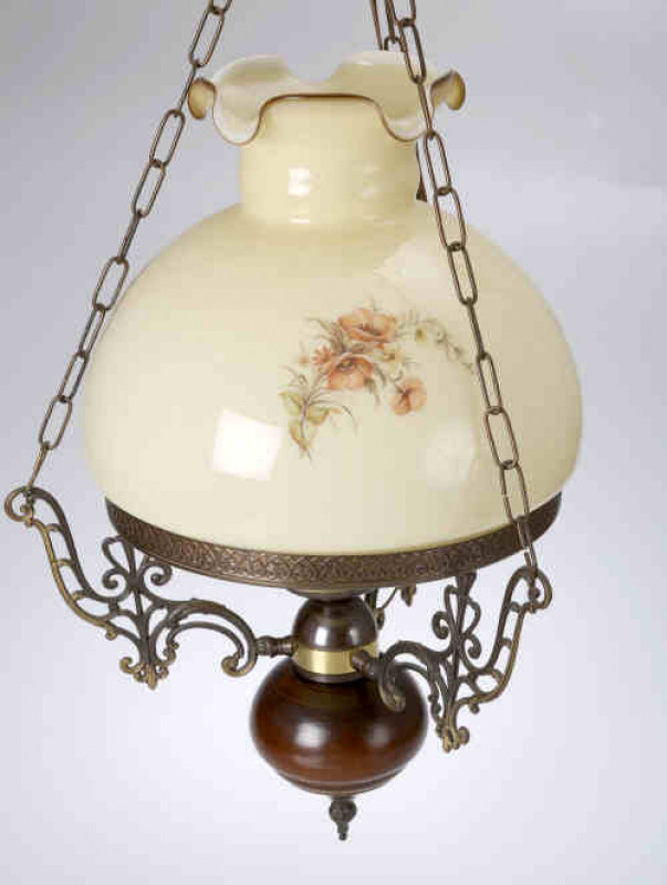 A Victorian style patinated metal hanging lamp, the scrolling openwork brackets supporting a floral decorated shade. Length of drop 79cm