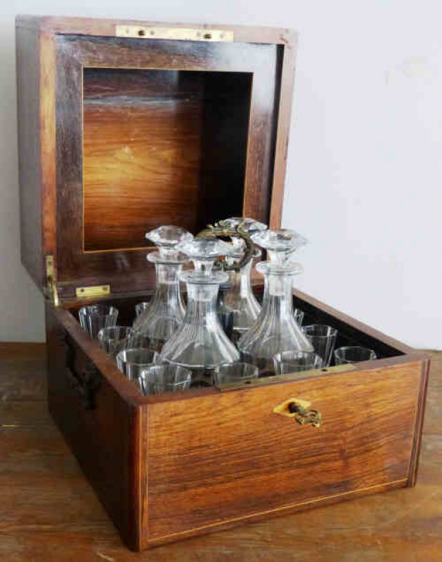 A 19th century rosewood and inlaid decanter box, the square hinged cover inlaid with the word LIQUEURS, the interior fitted with decanters and glasses. 27cm by 30cm by 30cm