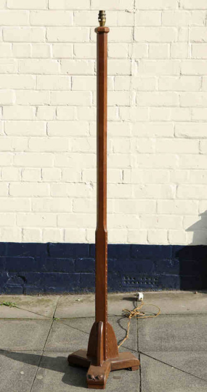 A Yorkshire oak standard lamp, the faceted standard raised on a triform platform base, with double acorn signature, monogrammed and dated 1965. 1.52m to top of fitting