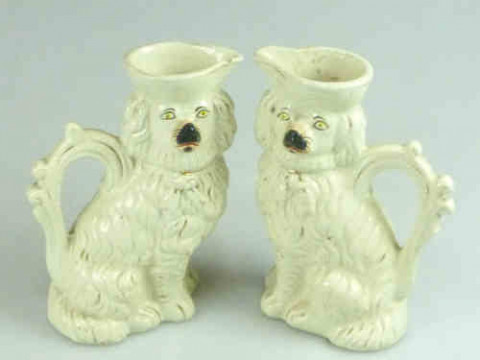 Pair of 19th Century Staffordshire Pottery Jugs in the form of seated...