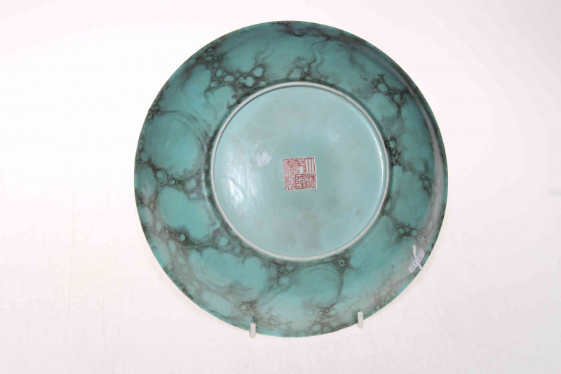 Chinese green mottled glazed saucer dish, iron red mark, 24cm diameter.