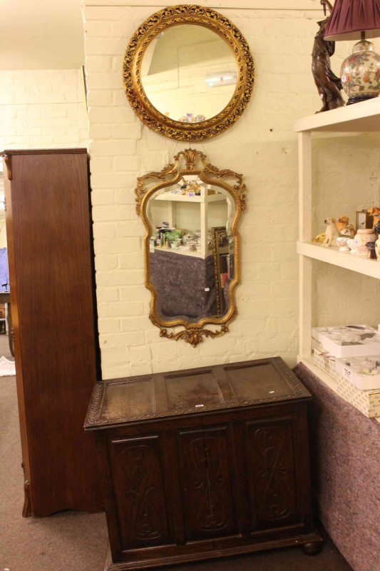Oak hall wardrobe, carved oak blanket box and two gilt framed wall mirrors (4).
