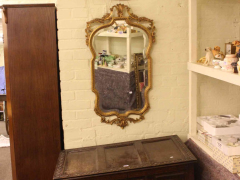 Oak hall wardrobe, carved oak blanket box and two gilt framed wall mirrors (4). thumbnail