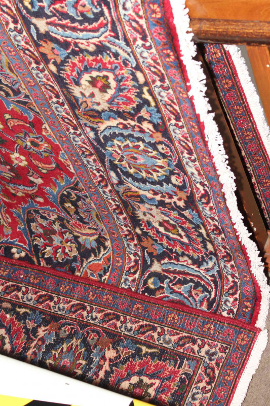 Large hand made Iranian red ground carpet from the Mashad region, 395 by 290cm.