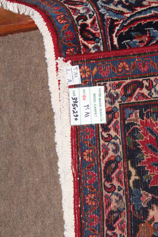 Large hand made Iranian red ground carpet from the Mashad region, 395 by 290cm.