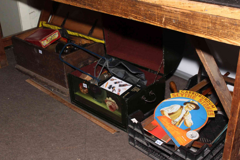 Three boxes of tools including levels, saws and tool auction catalogues.