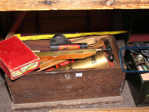 Three boxes of tools including levels, saws and tool auction catalogues. thumbnail