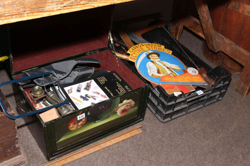 Three boxes of tools including levels, saws and tool auction catalogues.