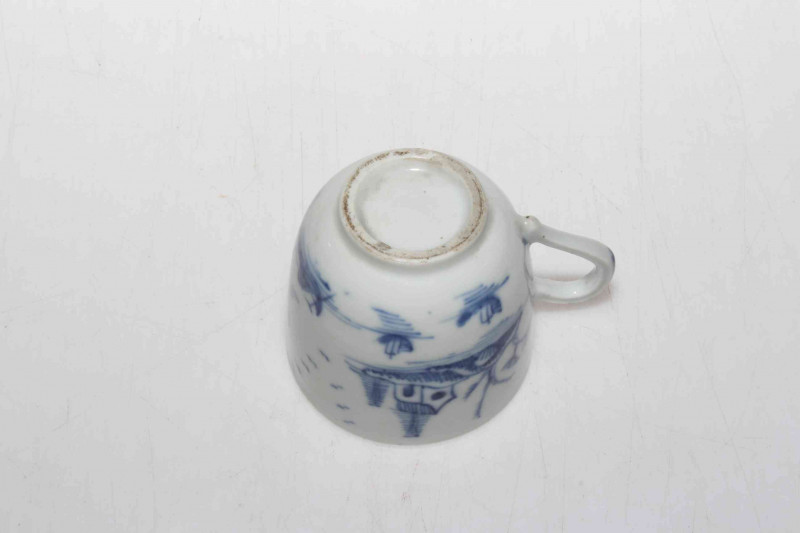 19th Century Oriental pottery blue and white cup decorated with trees and flowers.