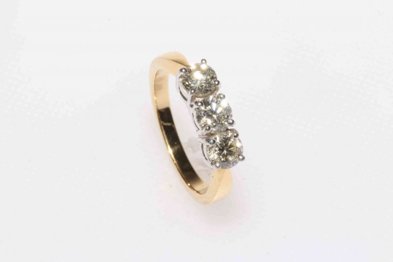 18 carat gold three stone diamond ring, approximate total diamond weight 1.25 carat, size M.