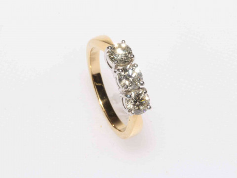 18 carat gold three stone diamond ring, approximate total diamond weight...