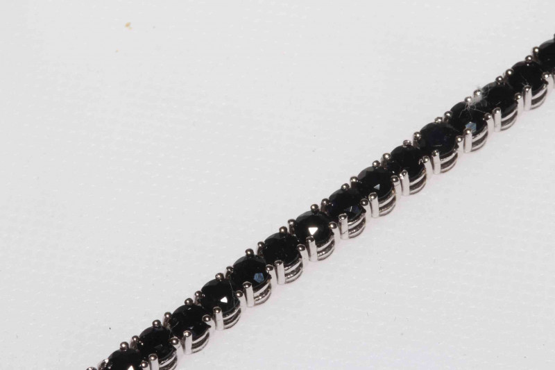 Sapphire line bracelet set in 18 carat white gold, having 53 sapphires totalling 7.5 carat, 18cm length.