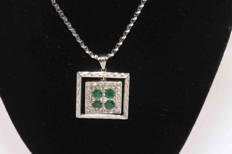 18 carat white gold, emerald and diamond pendant, with four emeralds and twenty small diamonds, 2.1cm square, with 18 carat white gold chain.