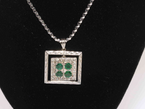 18 carat white gold, emerald and diamond pendant, with four emeralds and twenty small diamonds, 2.1cm square, with 18 carat white gold chain. thumbnail