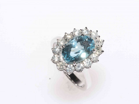 18 carat white gold, blue topaz and diamond cluster ring, having 8 carat...