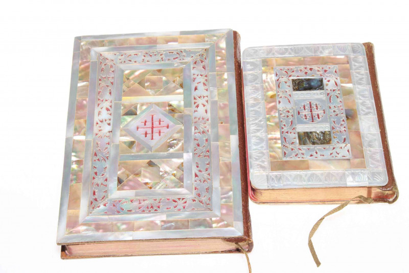 Two ornate mother of pearl veneered New Testament books, largest 16cm by 11cm.