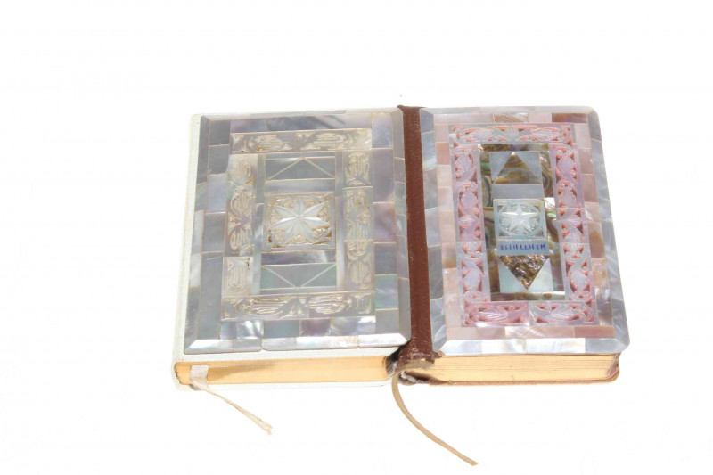 Two ornate mother of pearl veneered Prayer books, largest 12cm by 8.5cm.