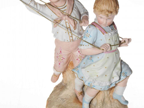 Heubach coloured bisque group of children playing, 30cm.