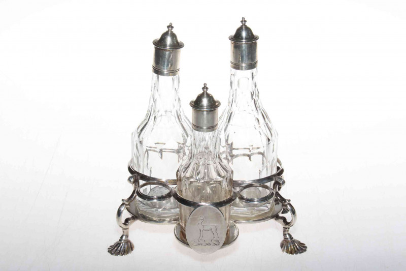 George III silver Warwick three bottle cruet on shell feet, makers mark R.P (R. Peaston) London 1766, with three bottles having matching crest, the frame with good hallmark to base, 17cm across.