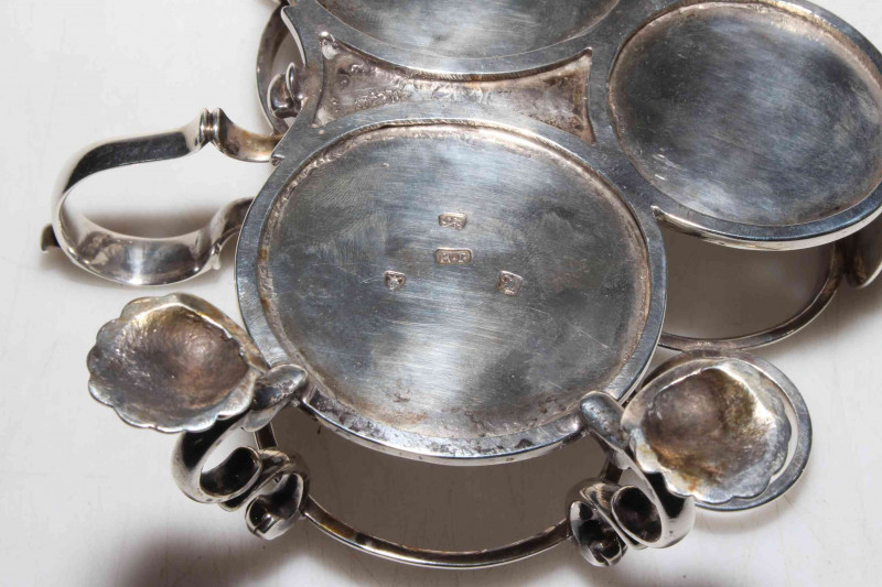 George III silver Warwick three bottle cruet on shell feet, makers mark R.P (R. Peaston) London 1766, with three bottles having matching crest, the frame with good hallmark to base, 17cm across.