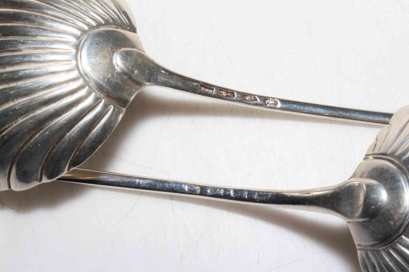 Matched pair of George III silver Old English pattern soup ladles with shell bowls, London 1774 and 1779, 32cm by 33cm lengths.