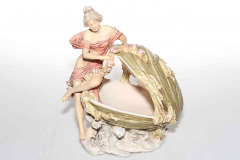 Good Royal Dux figure of maiden with flower garland seated with shell on sea scroll base, pink triangle mark, 28cm.